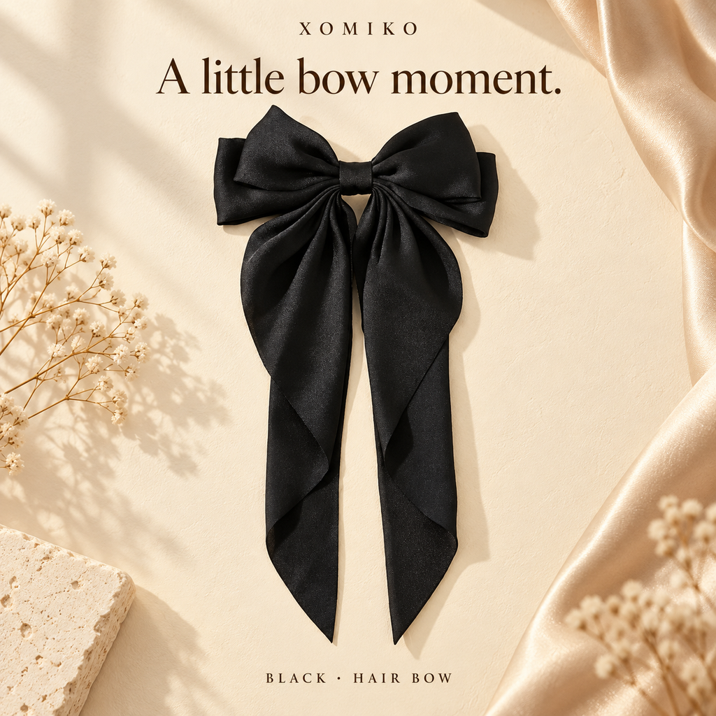 Xomiko black satin ribbon bow clip with long tails on a spring clip